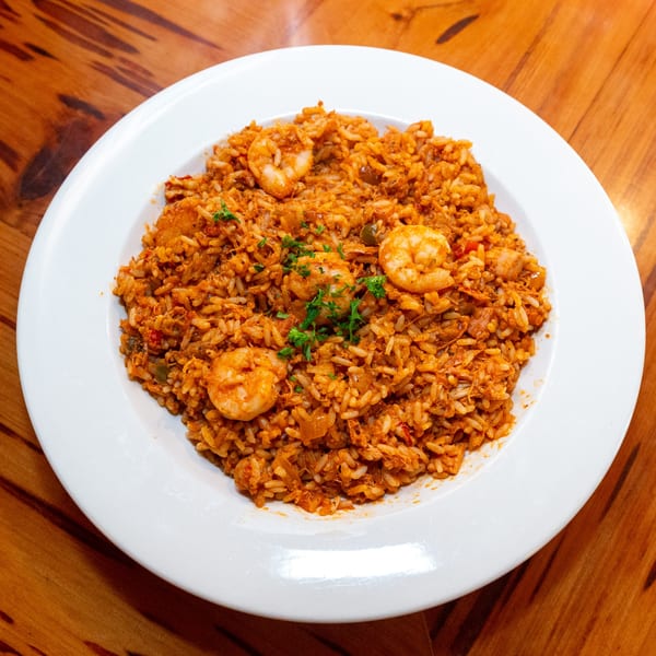 Big Daddy's NY jambalaya with shrimp and rice, garnished with fresh parsley on a white plate.
