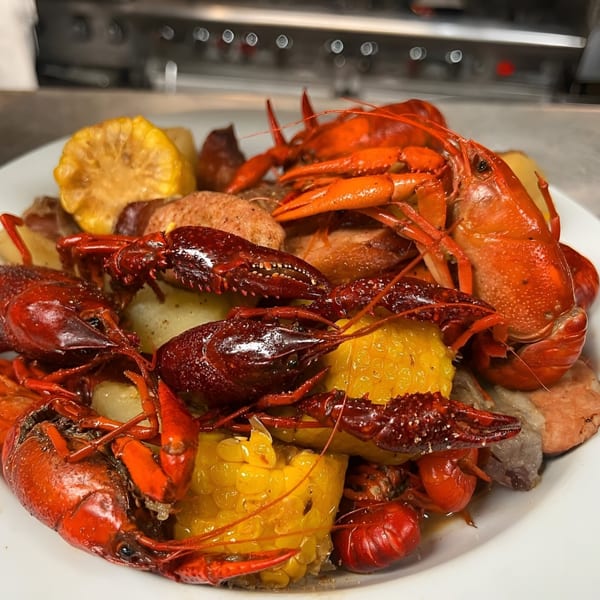 A platter of Big Daddy's NY BBQ crawfish boil with corn, potatoes, and sausage.